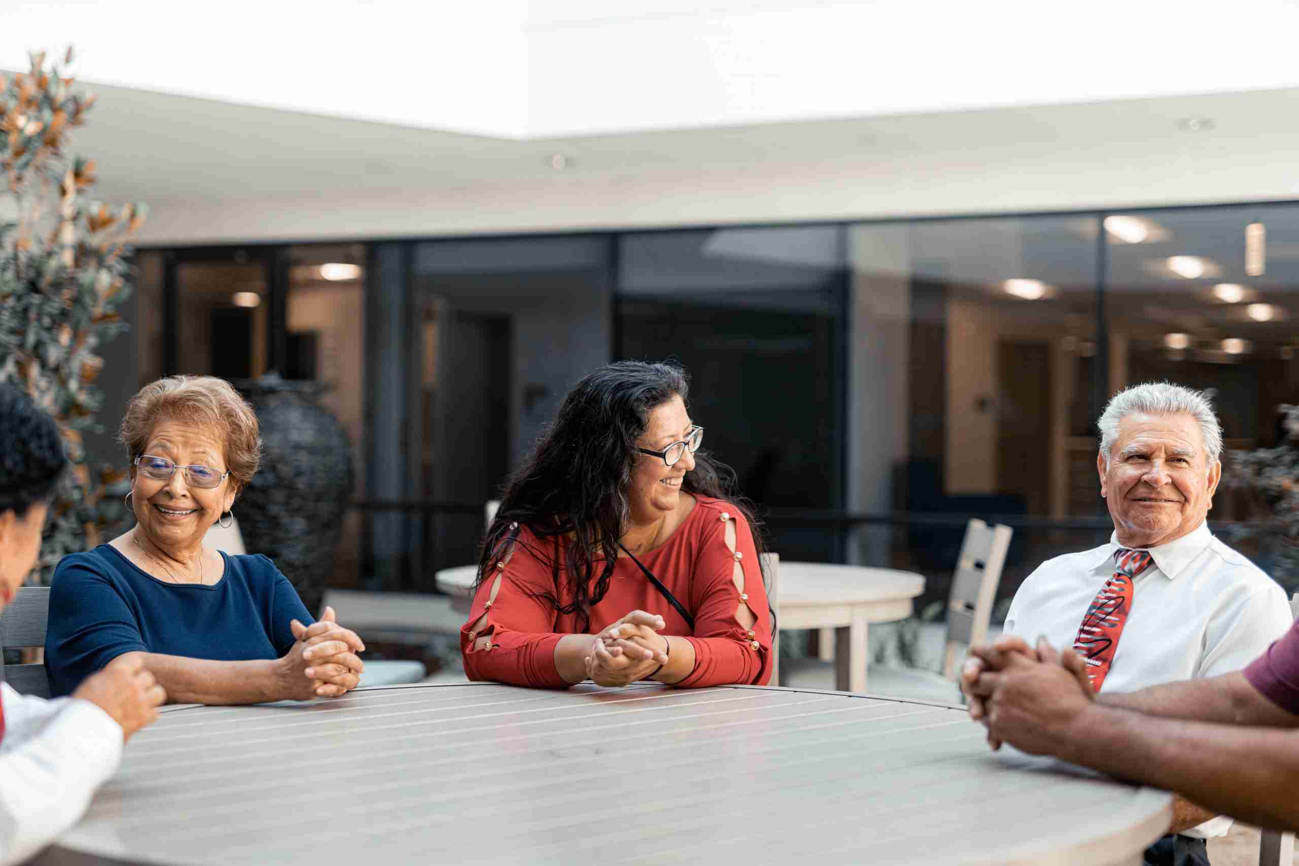 Three people at a table at Neighborhood Healthcare PACE